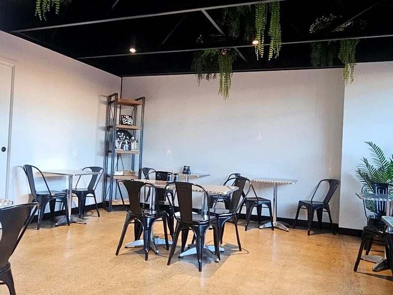 Commercial downlights — cafe fit-out with exposed black ceiling