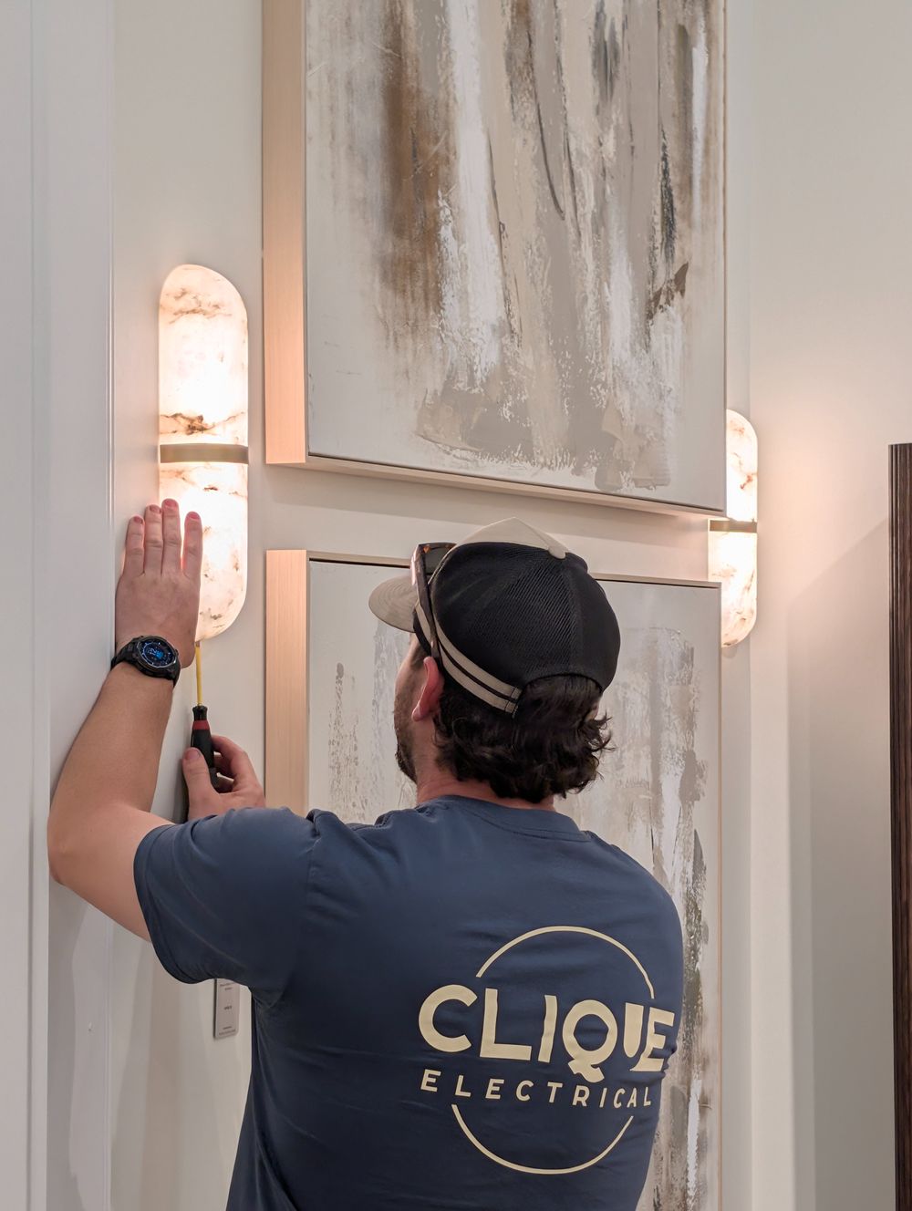 Clique Electrical electrician installing alabaster feature wall lights